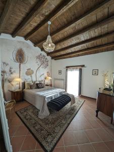 a bedroom with a large bed and a chandelier at Passo del Mattino in Locati +116 photos