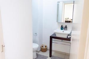 a bathroom with a sink and a toilet at Serenity Escape Windhoek in Windhoek