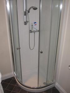 a shower with a glass enclosure in a bathroom at Bosun's Rest in Beer