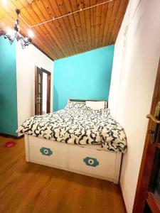 a bed in a room with a blue wall at Perla Azzurra - Forte dei Marmi - Cinque Terre in Montignoso