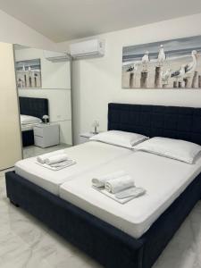 a bedroom with a large bed with towels on it at MAK apartment in Kaštela