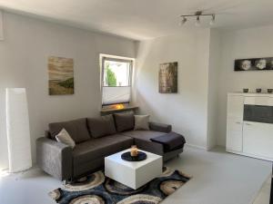 a living room with a couch and a coffee table at Ferienhaus Mayer Dahn Wohnung Neven in Dahn