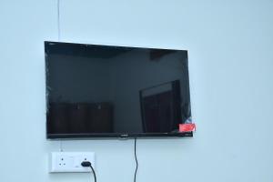 a flat screen tv sitting on top of a wall at Independent House in Jaipur in Jaipur