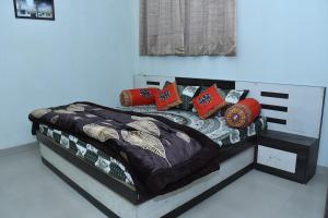 a bed with colorful pillows on it in a room at Independent House in Jaipur in Jaipur