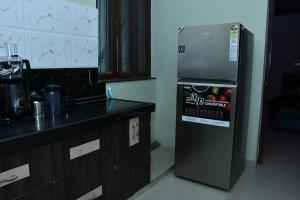 a kitchen with a refrigerator next to a counter at Independent House in Jaipur in Jaipur