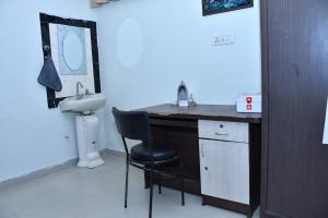 a bathroom with a sink and a desk with a chair at Independent House in Jaipur in Jaipur +12 photos