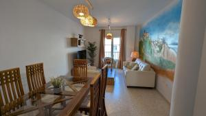a living room with a table and a couch at Atico Arcos Terraza Relax in Arcos de la Frontera