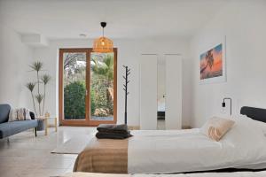 a white bedroom with a large bed and a window at Villa -Heated pool -Amazing view -Ideal for groups in Mijas +92 photos