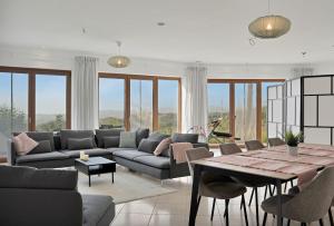 a living room with a couch and a table at Villa -Heated pool -Amazing view -Ideal for groups in Mijas
