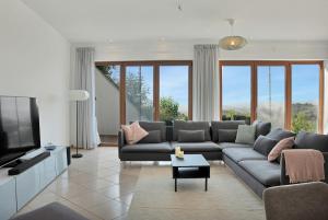 a living room with a couch and a tv at Villa -Heated pool -Amazing view -Ideal for groups in Mijas