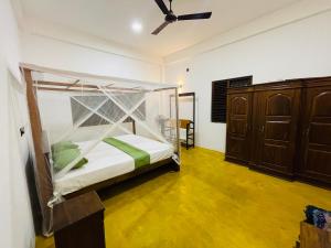 a bedroom with a bed with a mosquito net at 07th Heaven Villa in Tangalle +57 photos