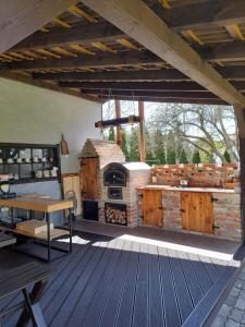 an outdoor patio with a stone fireplace and a table at Apartament Agro&Art in Płocin