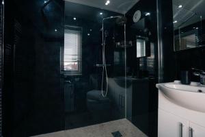 a black bathroom with a shower and a sink at St Nicholas Haven in York +90 photos