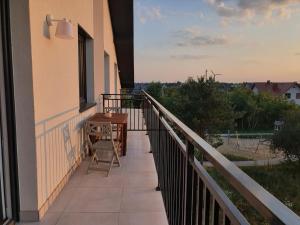 a balcony of a building with a table on it at przytulny apartament in Mielec