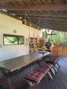 a large wooden table in a patio with benches at Apartament Agro&Art in Płocin