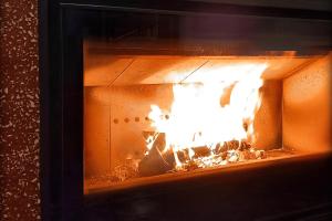 a fireplace with a fire in it at Casa La Vall in Beniali