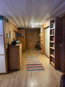 a room with a kitchen with wooden floors and a refrigerator at Åre, Trillevallen stuga Privaten in Undersåker +28 photos