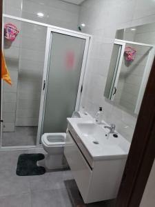 a bathroom with a sink and a toilet and a shower at Apprtmt jury de luxe in Nador +31 photos