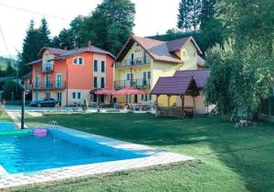 a house with a swimming pool in the yard at Green Villas Tjentiste in Tjentište