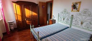 a bedroom with a bed with a blue comforter at Casa vacanze Mare Monti in Grottammare