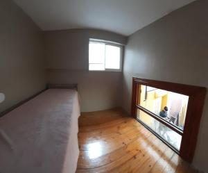 a bedroom with a large bed and a window at Casa Escalera Caracol in Buenos Aires