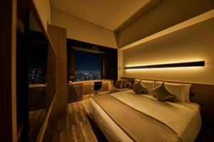a hotel room with a large bed and a window at The Royal Park Hotel Iconic Tokyo Shiodome in Tokyo