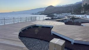 a wooden boardwalk next to the ocean with a view at Beach LOFT Tabaiba in Tabaiba