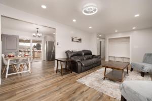 a living room with a leather couch and a table at Basin Staycation in Vernal