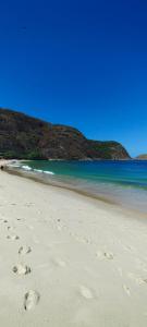 a pair of footprints in the sand on a beach at Vereda da Lagoa in Niterói