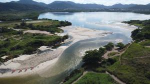 an aerial view of a river with a beach at Vereda da Lagoa in Niterói