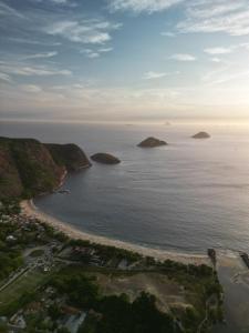an aerial view of a beach with islands in the water at Vereda da Lagoa in Niterói