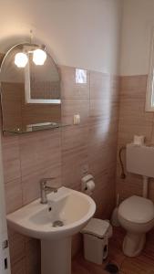 a bathroom with a sink and a toilet at Dimitris Studios in Paleokastritsa +58 photos