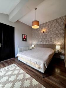 a bedroom with a large bed and a wall at Apartment 17 in Mtskheta +53 photos