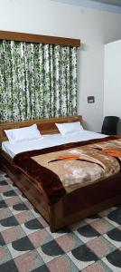 a large bed in a room with a window at The Ganga Home Stay in Prayagraj
