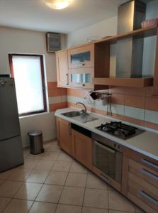 a kitchen with a sink and a stove top oven at Apartment Zaglav 3 - first sea row in Zaglav