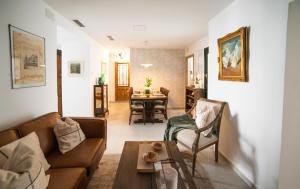 a living room with a couch and a table at Casa Hera - Boutique House in Alhaurín el Grande in Alhaurín el Grande