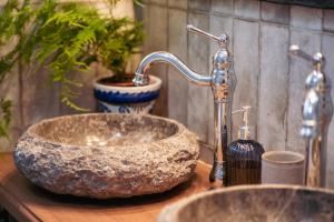 a bathroom sink with a stone vessel sink at Casa Hera - Boutique House in Alhaurín el Grande in Alhaurín el Grande +64 photos