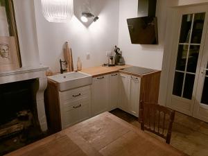 a small kitchen with a sink and a stove at La Petite Ecluse in Tanlay +7 photos