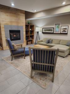 a living room with a couch and a table at Country Inn & Suites by Radisson, Indianapolis South, IN in Indianapolis