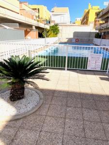 a palm tree in front of a white fence at VV Canary Islands 1 in San Miguel de Abona