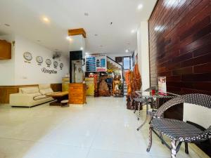 a room with a couch and chairs in a store at SAPHIA Hotel Hue in Hue