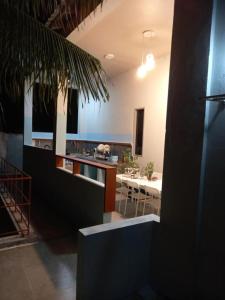 a room with a kitchen and a dining room with a table at Iruka Guesthouse in Bandara +4 photos