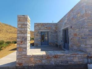 a stone building with a blue door on it at Akallis Villa in Galini