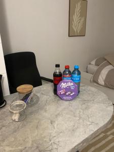 two bottles of water sitting on a marble table at Charmant studio à 20min de Paris in Créteil