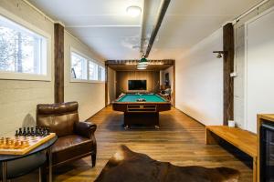 a billiard room with a pool table and a couch at Villa Välke - Relax In Style in Pyhätunturi