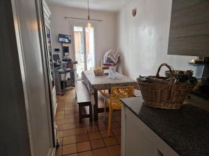 a kitchen with a table and a dining room at chambre pour 1 personne in Bagnols-sur-Cèze