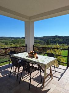 a table and chairs on a balcony with a view at Zöld Terasz Vendégház in Egerszalók