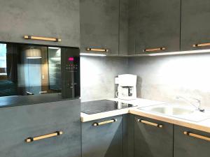 a kitchen with a sink and a counter top at Charmant appart 5 pers, accès piscine, parking, Plagne 1800 - FR-1-351-52 in Plagne 1800 +11 photos