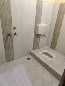 a bathroom with a toilet and a shower at Kailashi bhawan in Prayagraj +8 photos