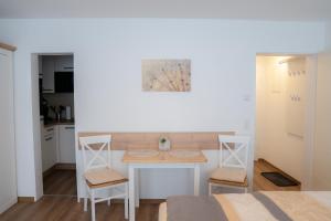 a small kitchen with a table and two chairs at Ferienwohnung Clara in Sonthofen